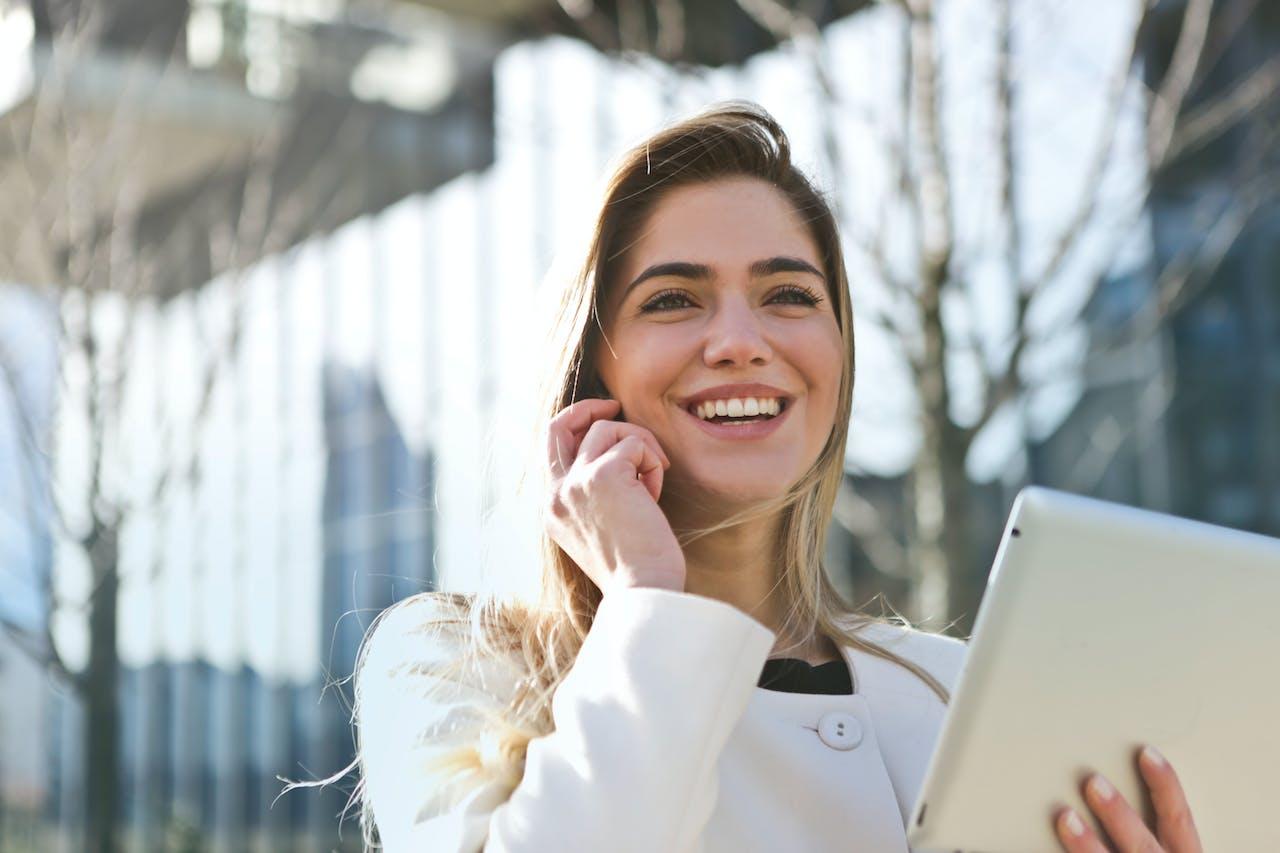 Happy woman using iPad