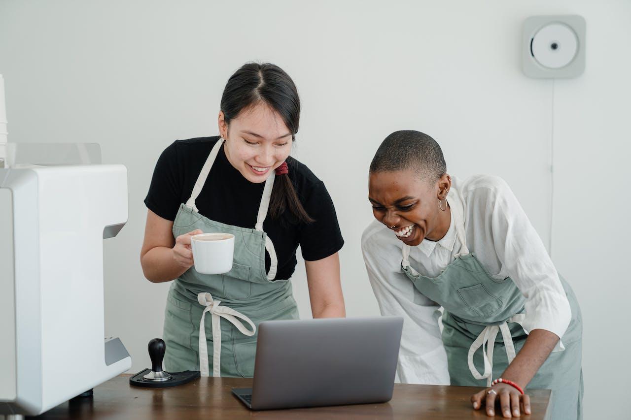 Women watching video on laptop