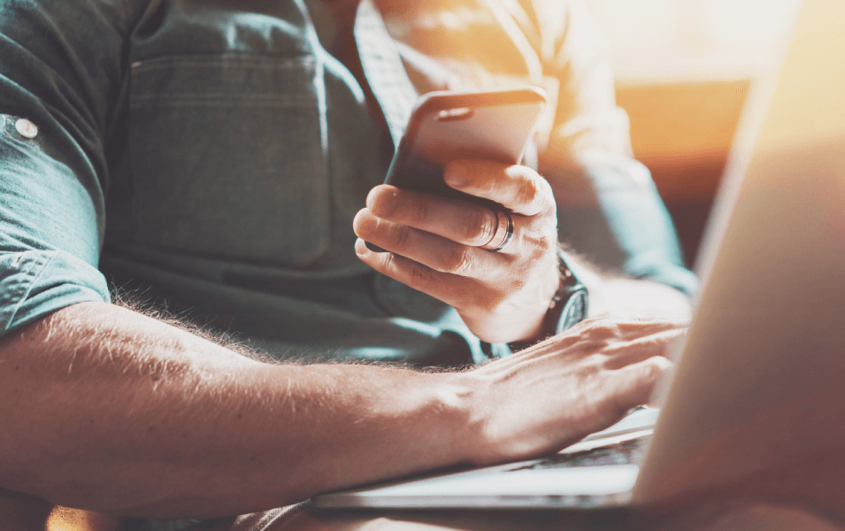 Man on his phone and computer