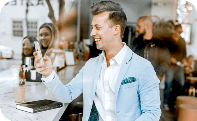 Young businessman using SMS marketing on his smartphone