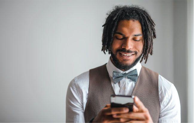 Business man texting sample text messages to customers at event 