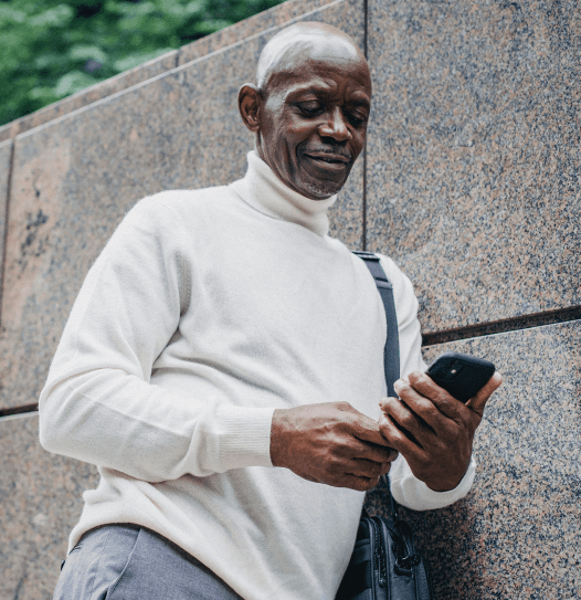 older man receiving texts on phone
