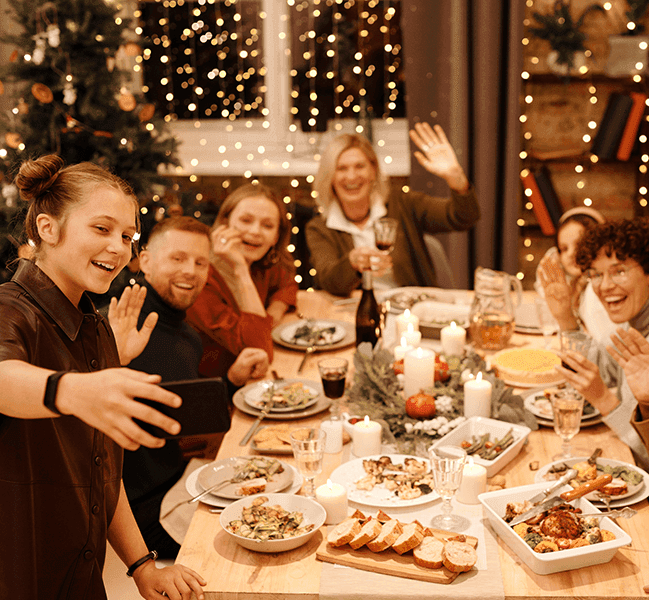 Happy people eating dinner at Christmas