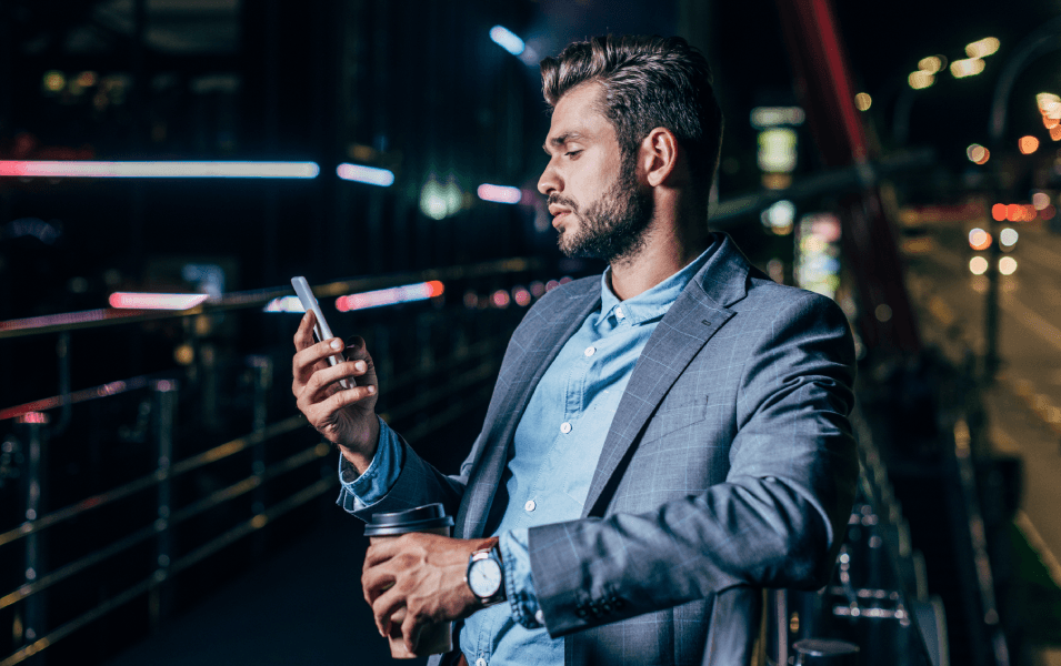 Business man texting outside