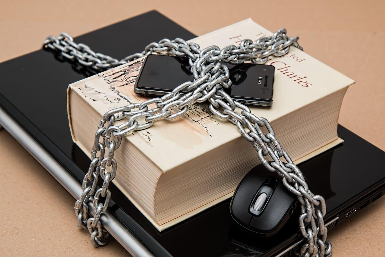 Chains locking computer, book, and phone