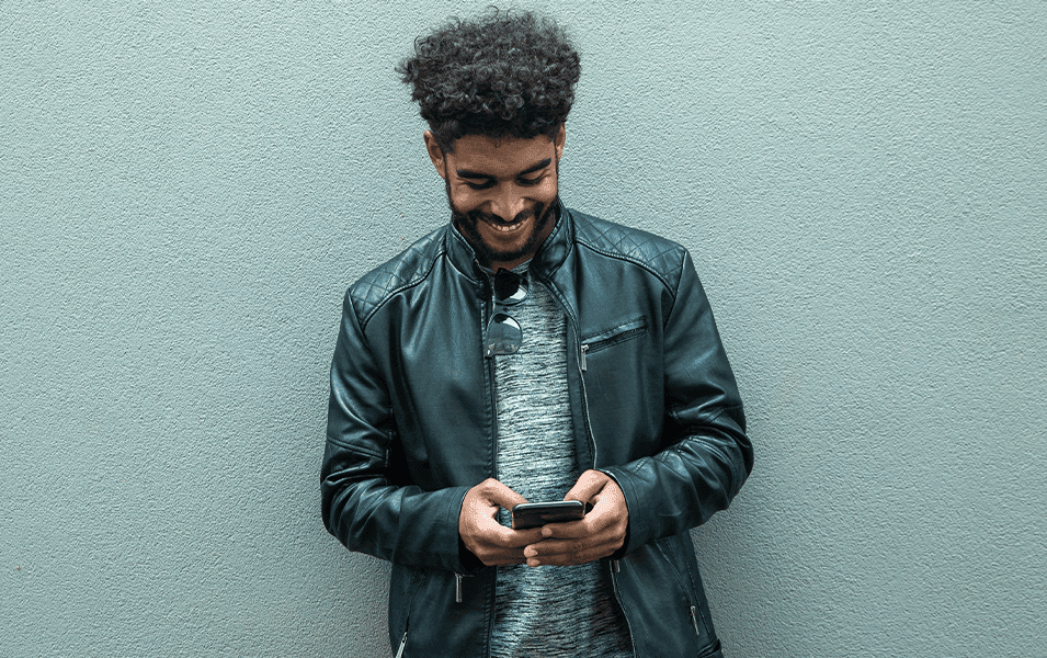 Man smiling and texting