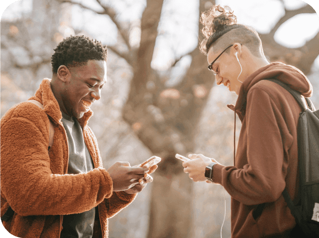two men smiling and texting